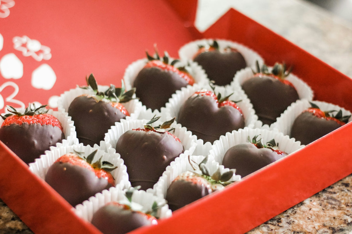 Chocolate-dipped strawberries in a bright red gift box